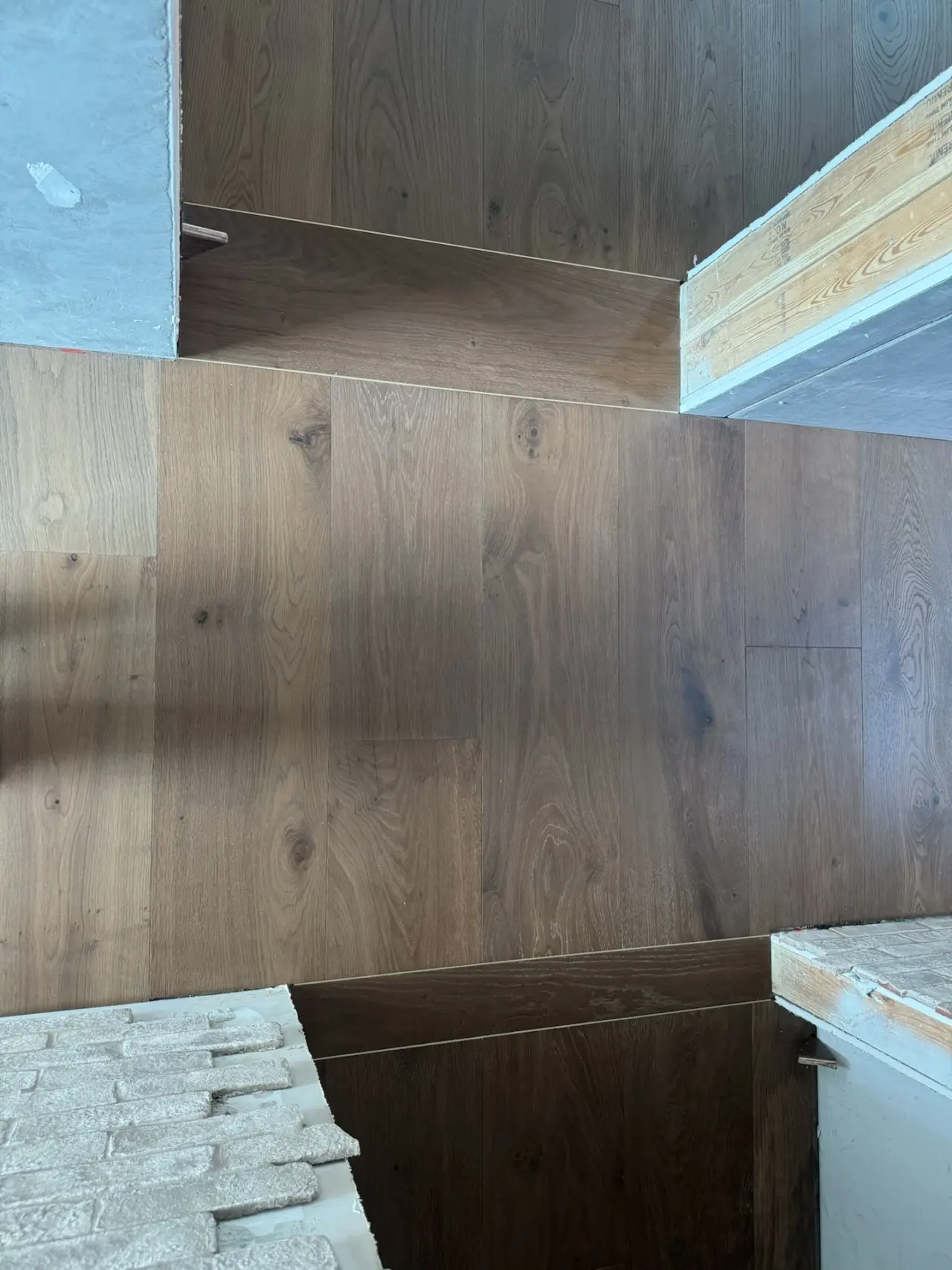 Details · A custom wood transition at every doorway.