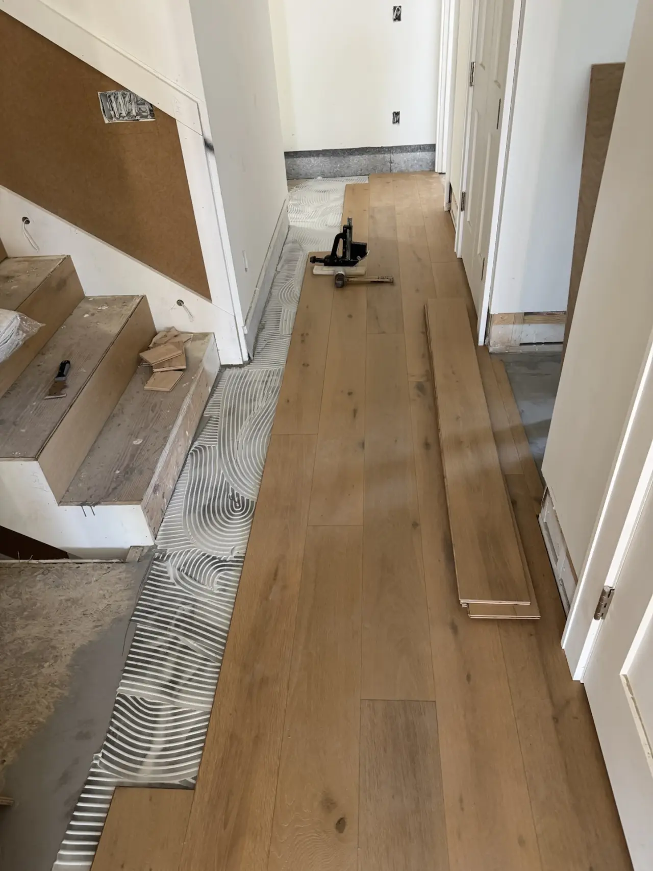 Installation · Adhesive troweled section by section, boards set to the layout lines.