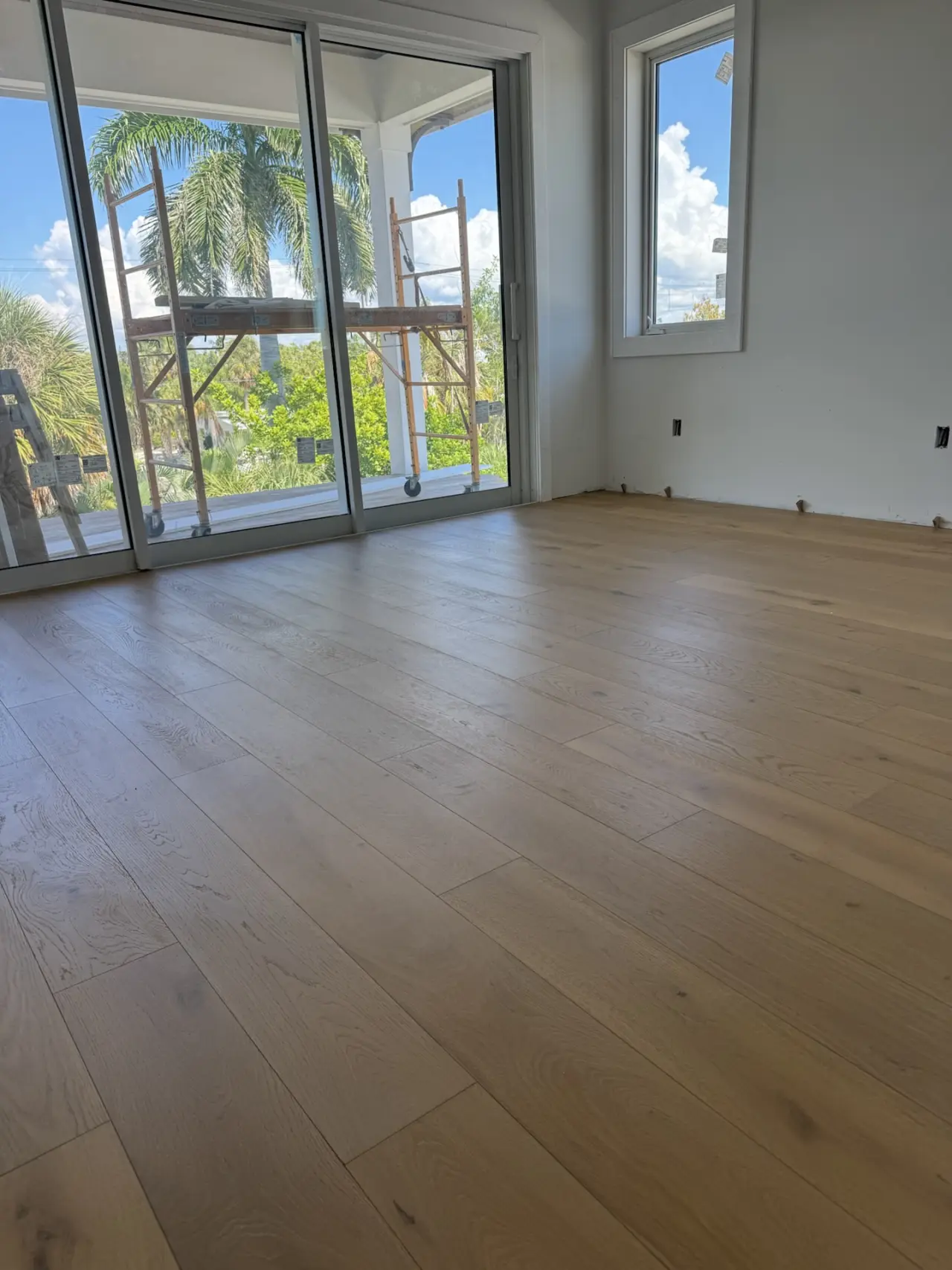 After: Living room · same corner, slab to finished floor