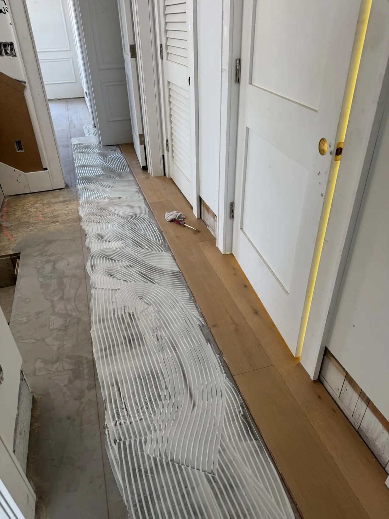 Installation · Adhesive troweled section by section, boards set to the layout lines.