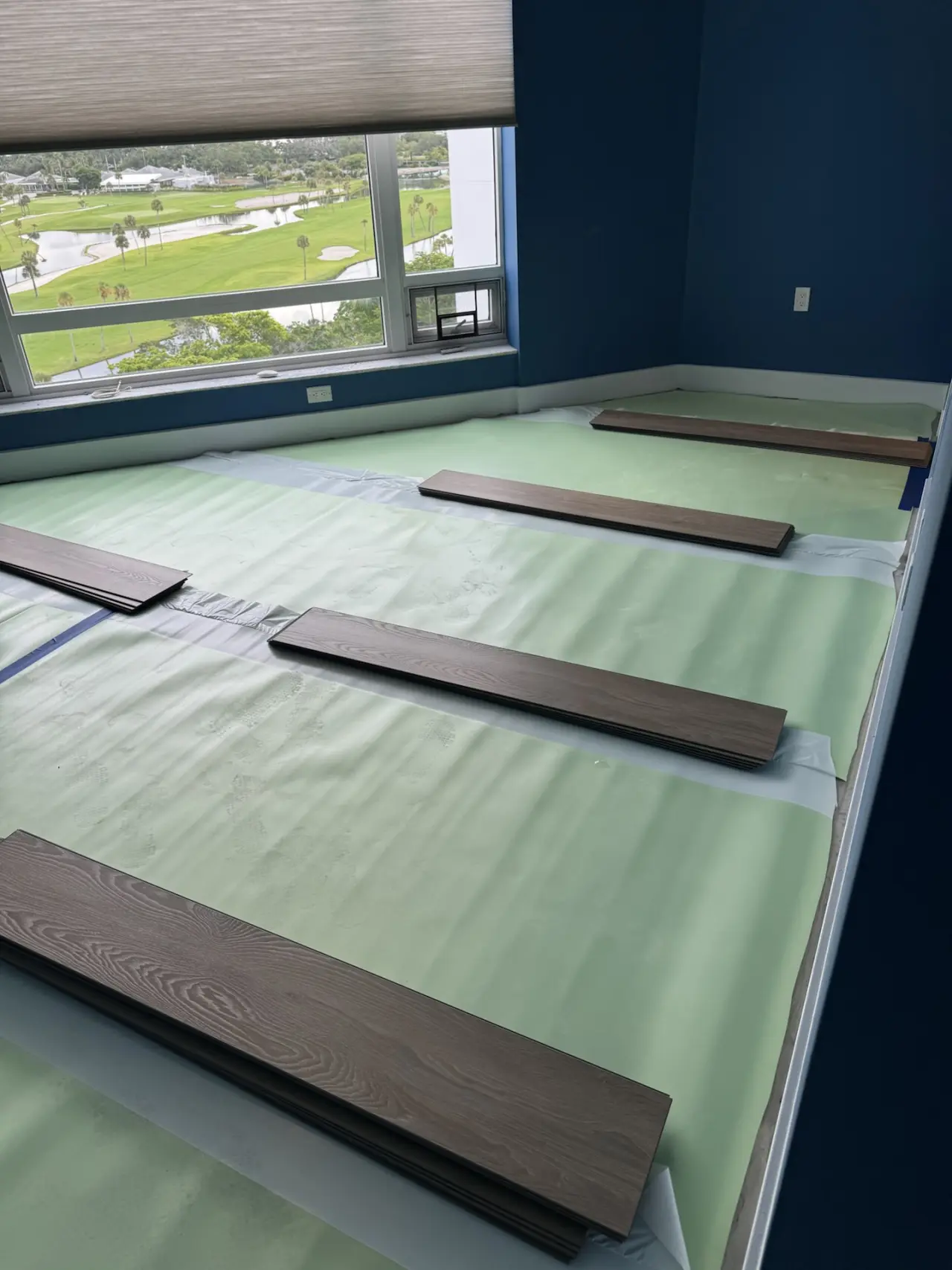 Underlayment · Underlayment rolled out beneath the vinyl, first planks laid out.