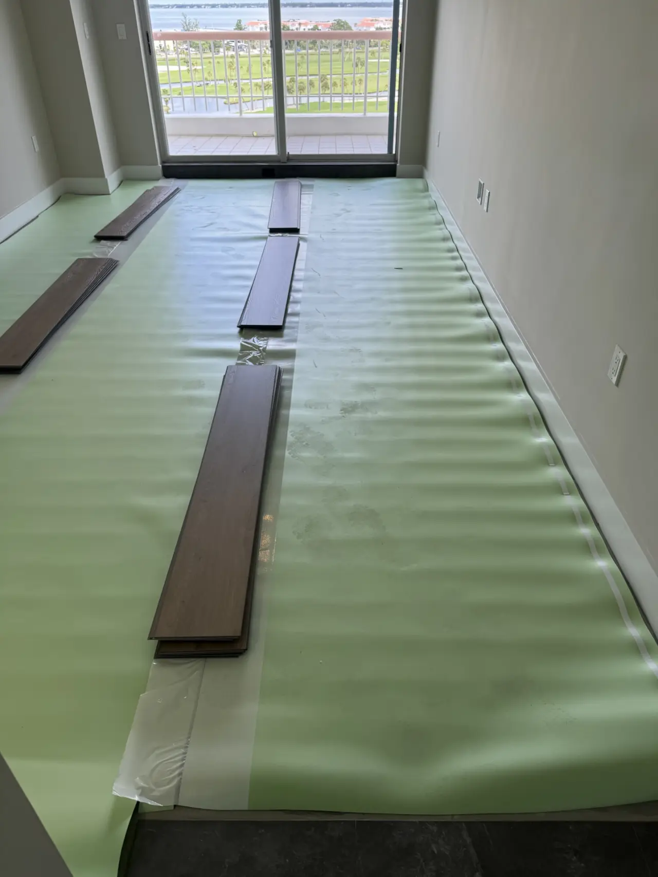 Underlayment · Underlayment rolled out beneath the vinyl, first planks laid out.