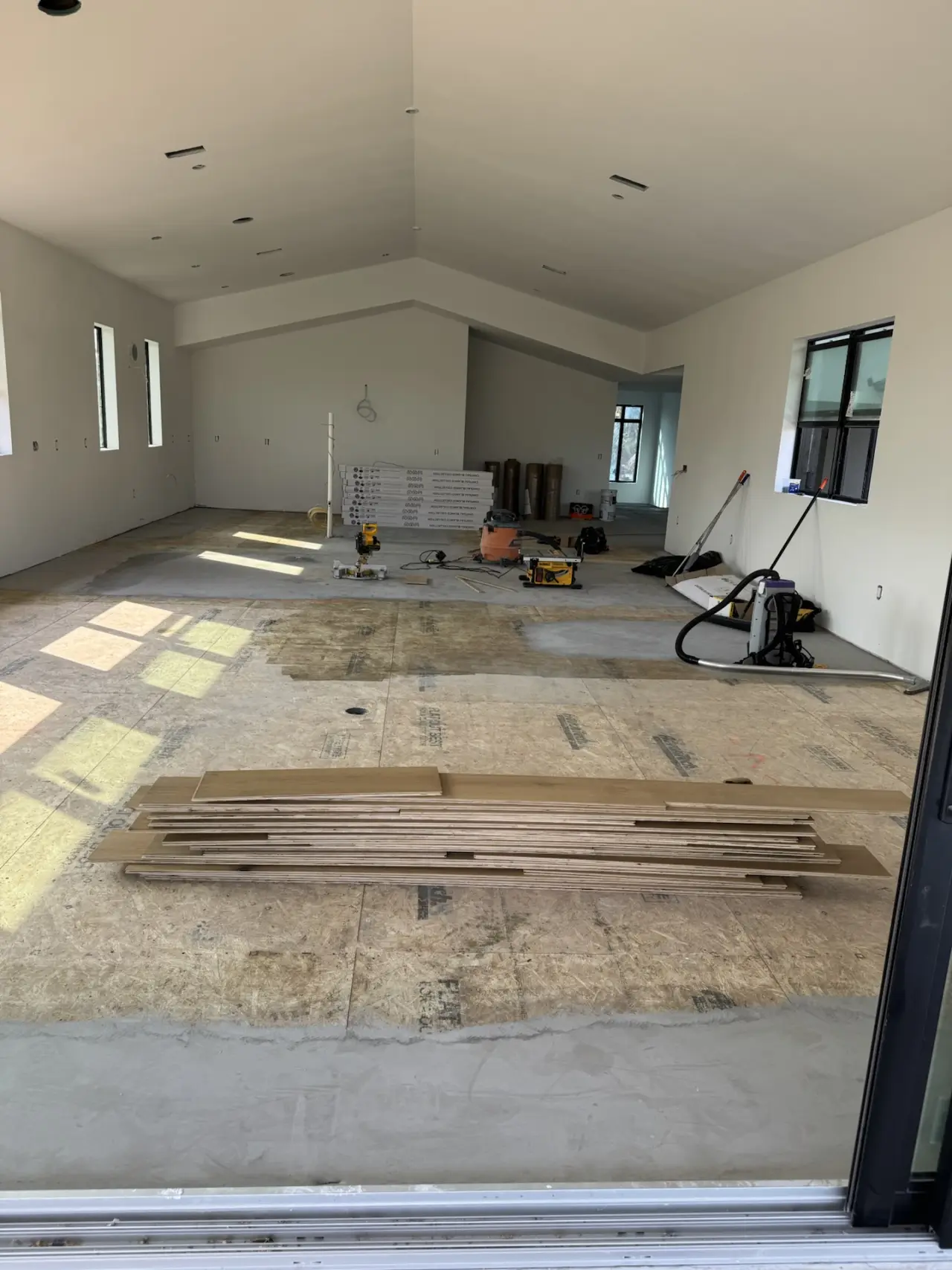 Prep · Plywood sanded and self-leveling compound applied where the floor needed it.